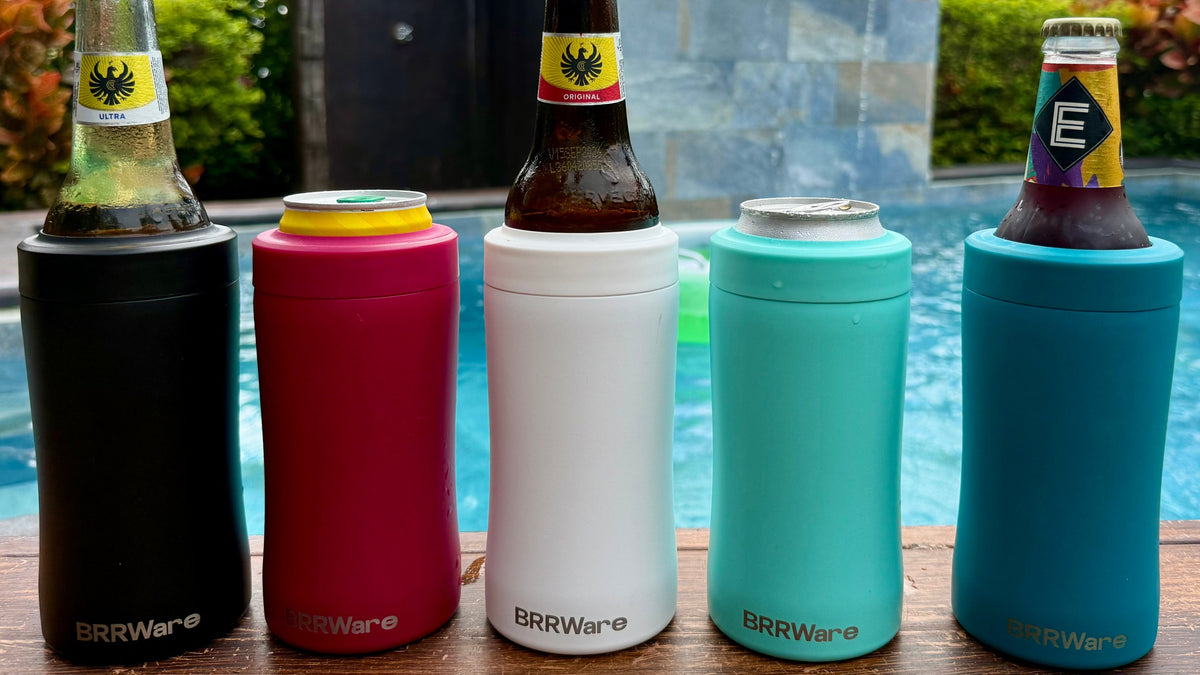 Five colorful can coolers with bottles against a poolside background
